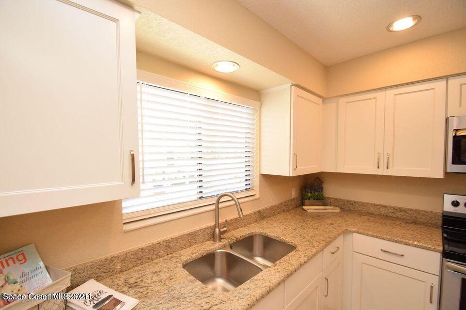 670 Cedar Side Circle Northeast Palm Bay, FL 32905 - Photo 8 of 22 a kitchen with a sink cabinets and window