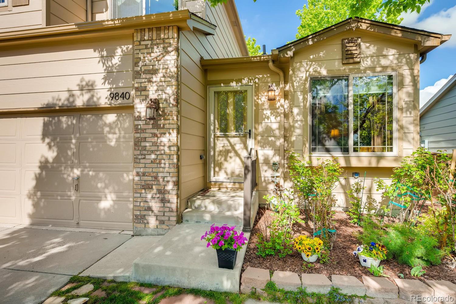 9840 South Castle Ridge Circle Highlands Ranch, CO 80129 - Photo 2 of 28 a front view of a house with a yard