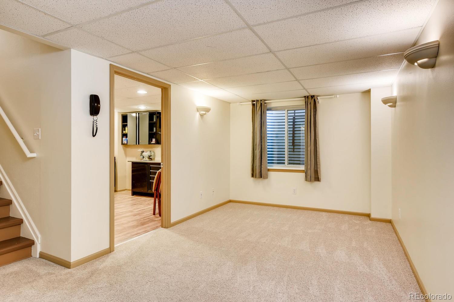 9840 South Castle Ridge Circle Highlands Ranch, CO 80129 - Photo 21 of 28 an empty room with windows