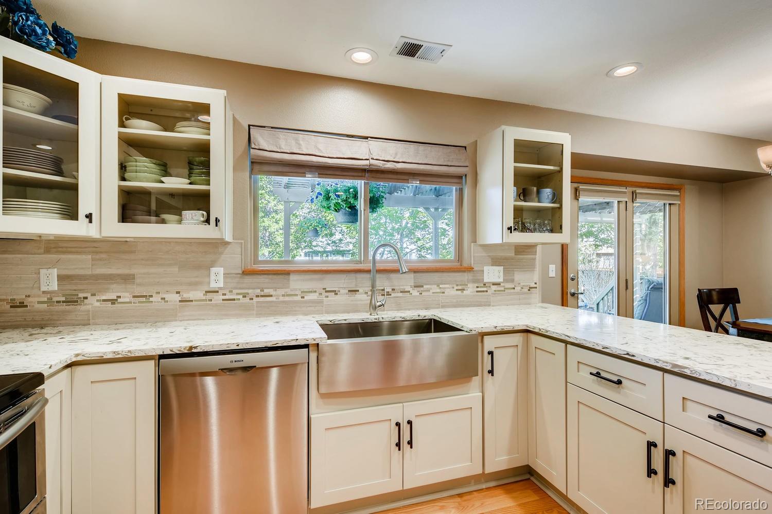 9840 South Castle Ridge Circle Highlands Ranch, CO 80129 - Photo 8 of 28 a kitchen with a sink stove and cabinets
