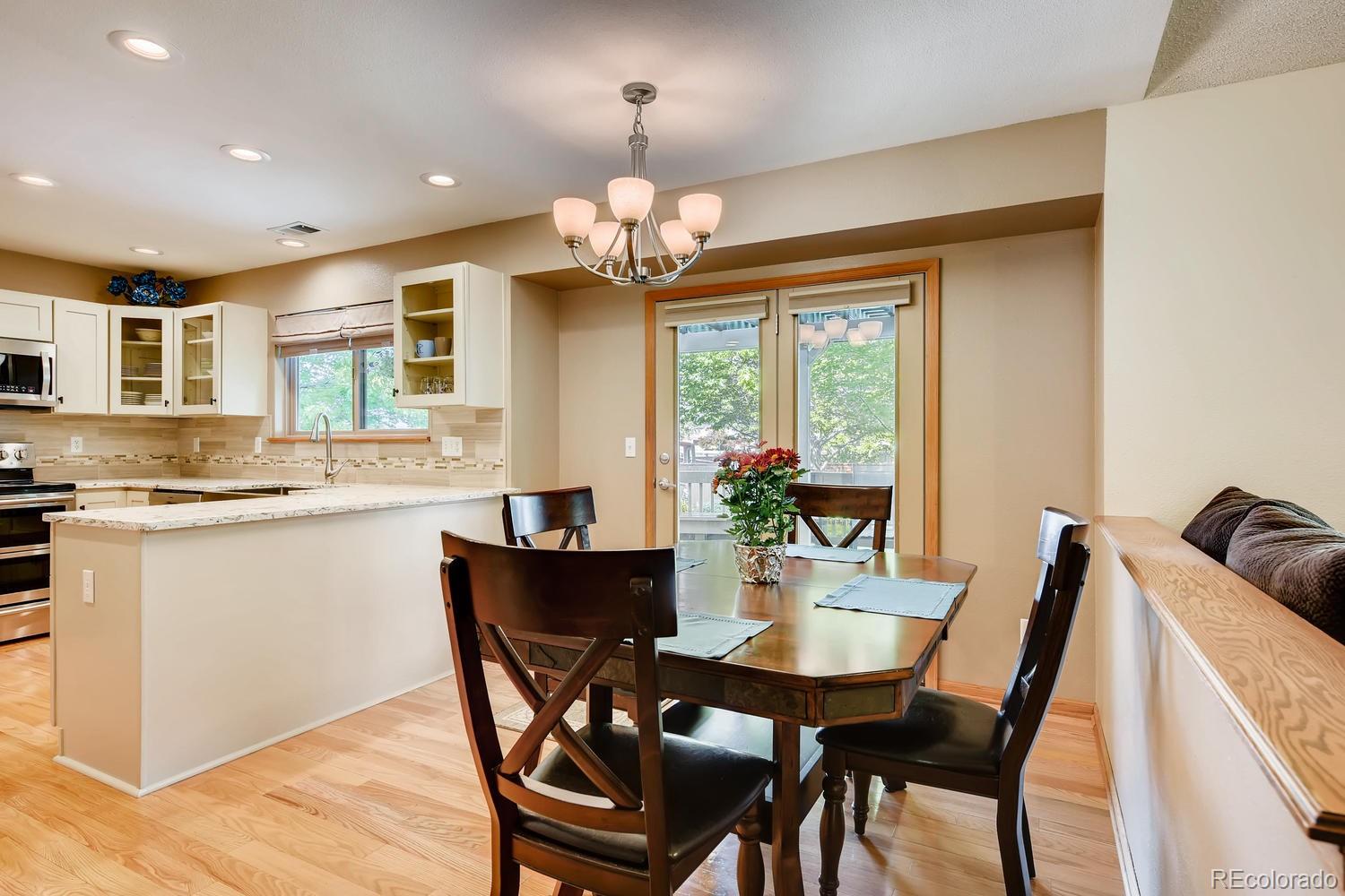9840 South Castle Ridge Circle Highlands Ranch, CO 80129 - Photo 9 of 28 a view of a dining room with furniture window and wooden floor