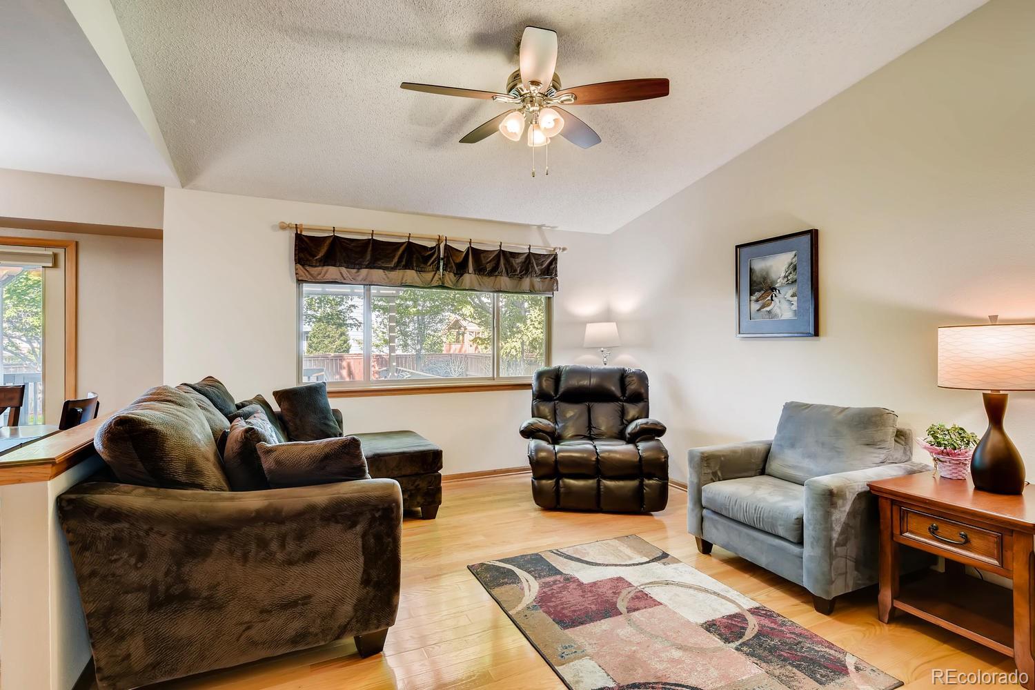 9840 South Castle Ridge Circle Highlands Ranch, CO 80129 - Photo 10 of 28 a living room with furniture and a large window