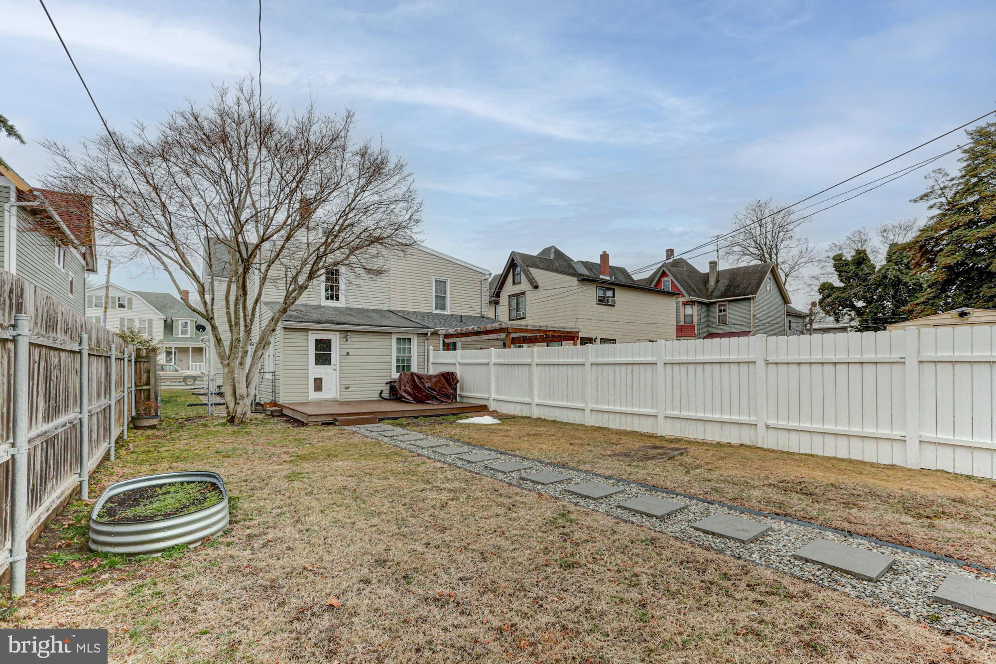 421 Main Street Clayton, DE 19938 - Photo 11 of 77 a view of a backyard with large trees