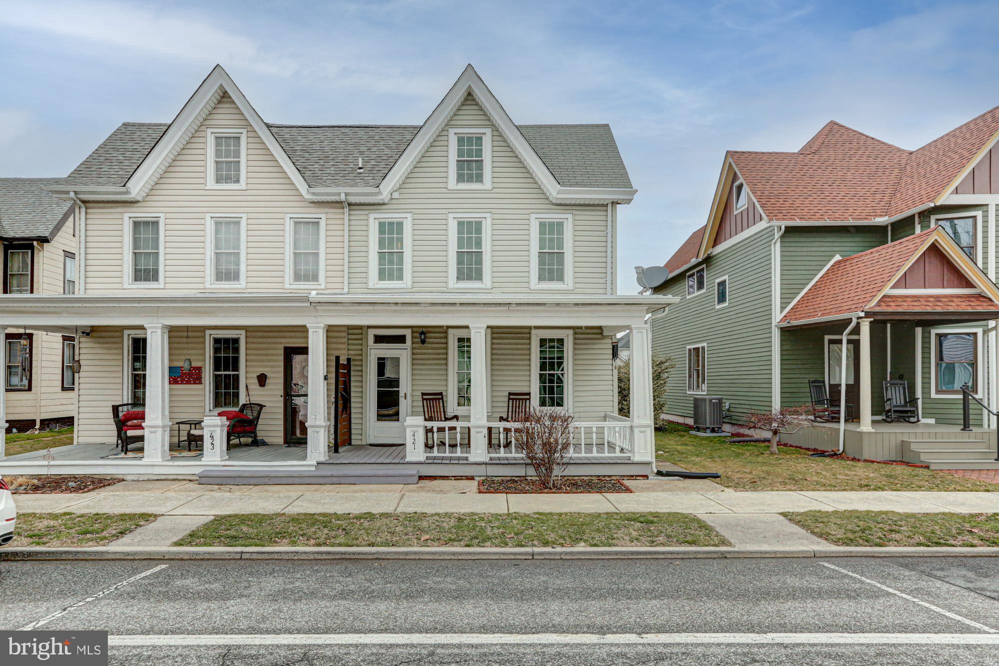 421 Main Street Clayton, DE 19938 - Photo 4 of 77 a view of a white house with large windows and a table