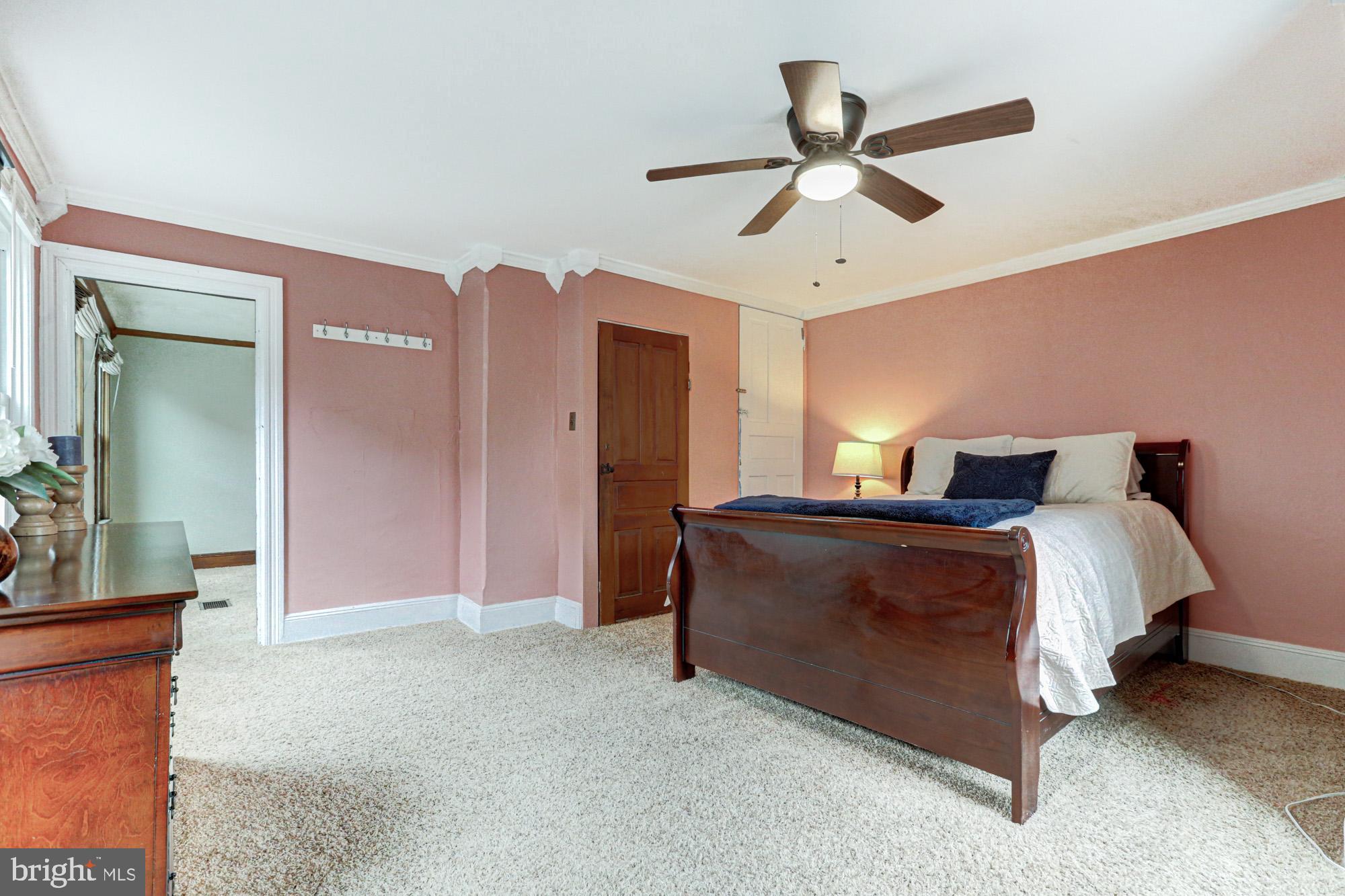 421 Main Street Clayton, DE 19938 - Photo 44 of 77 a spacious bedroom with a bed and a ceiling fan
