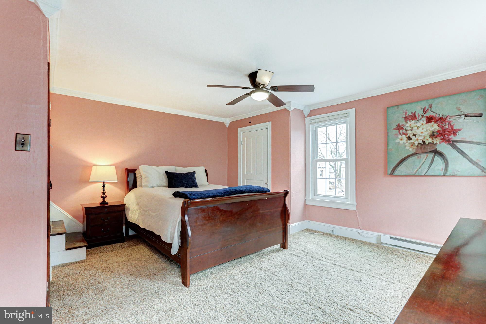 421 Main Street Clayton, DE 19938 - Photo 46 of 77 a spacious bedroom with a bed and a chandelier