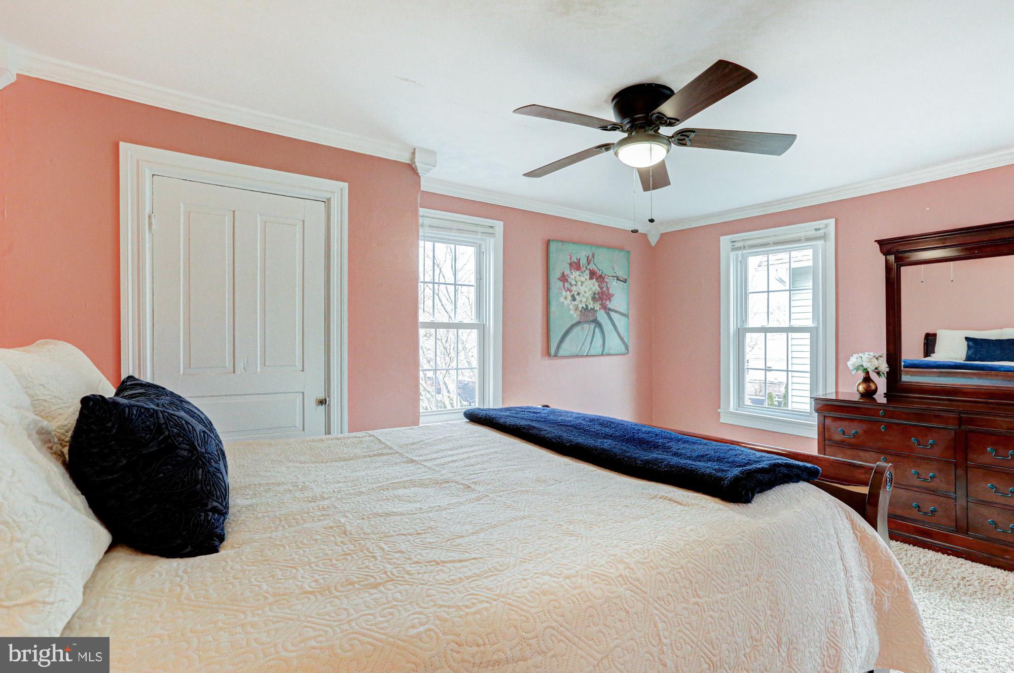 421 Main Street Clayton, DE 19938 - Photo 47 of 77 a bedroom with a bed window and a chandelier