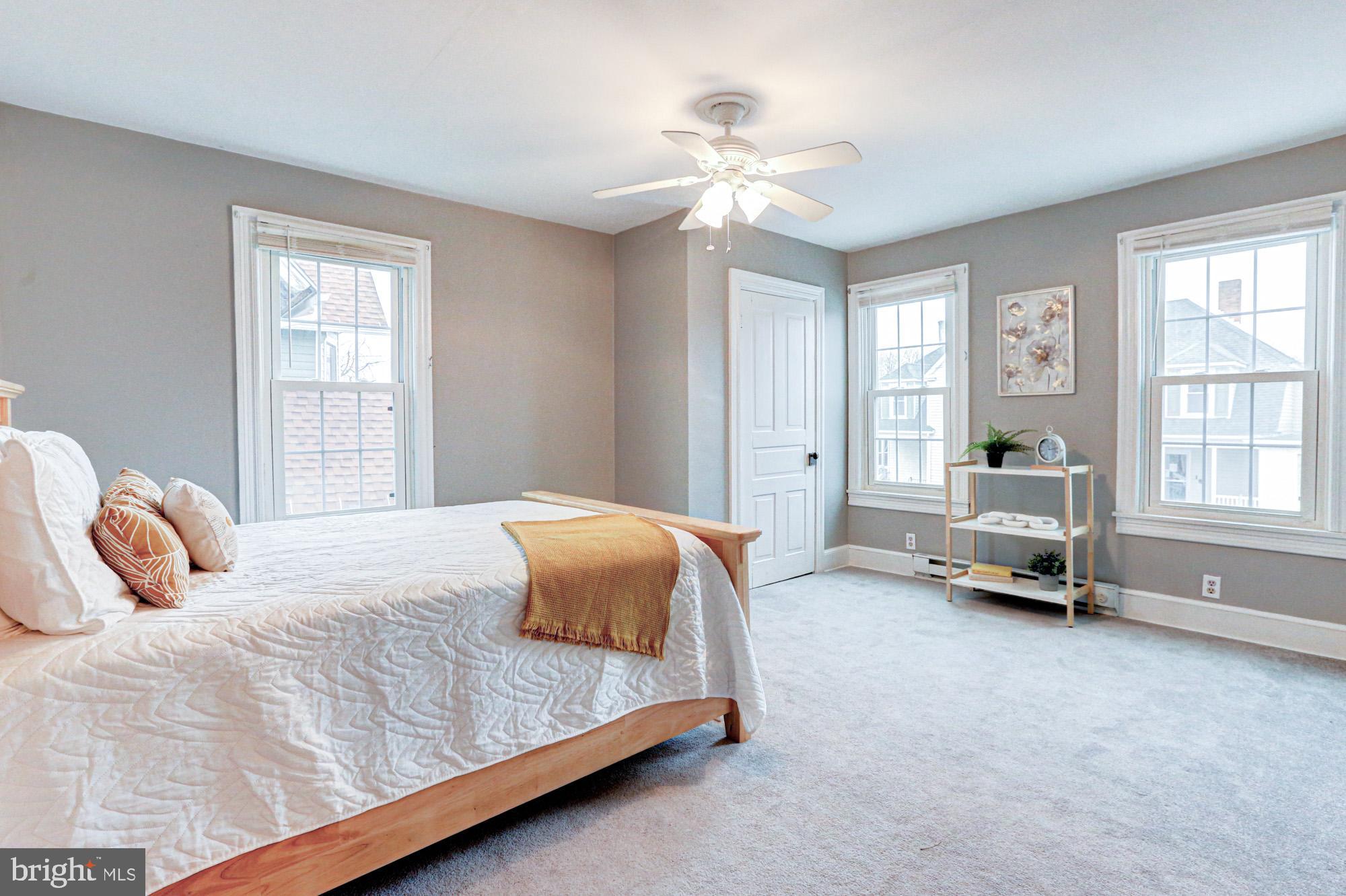 421 Main Street Clayton, DE 19938 - Photo 57 of 77 a bedroom with a bed and a chandelier