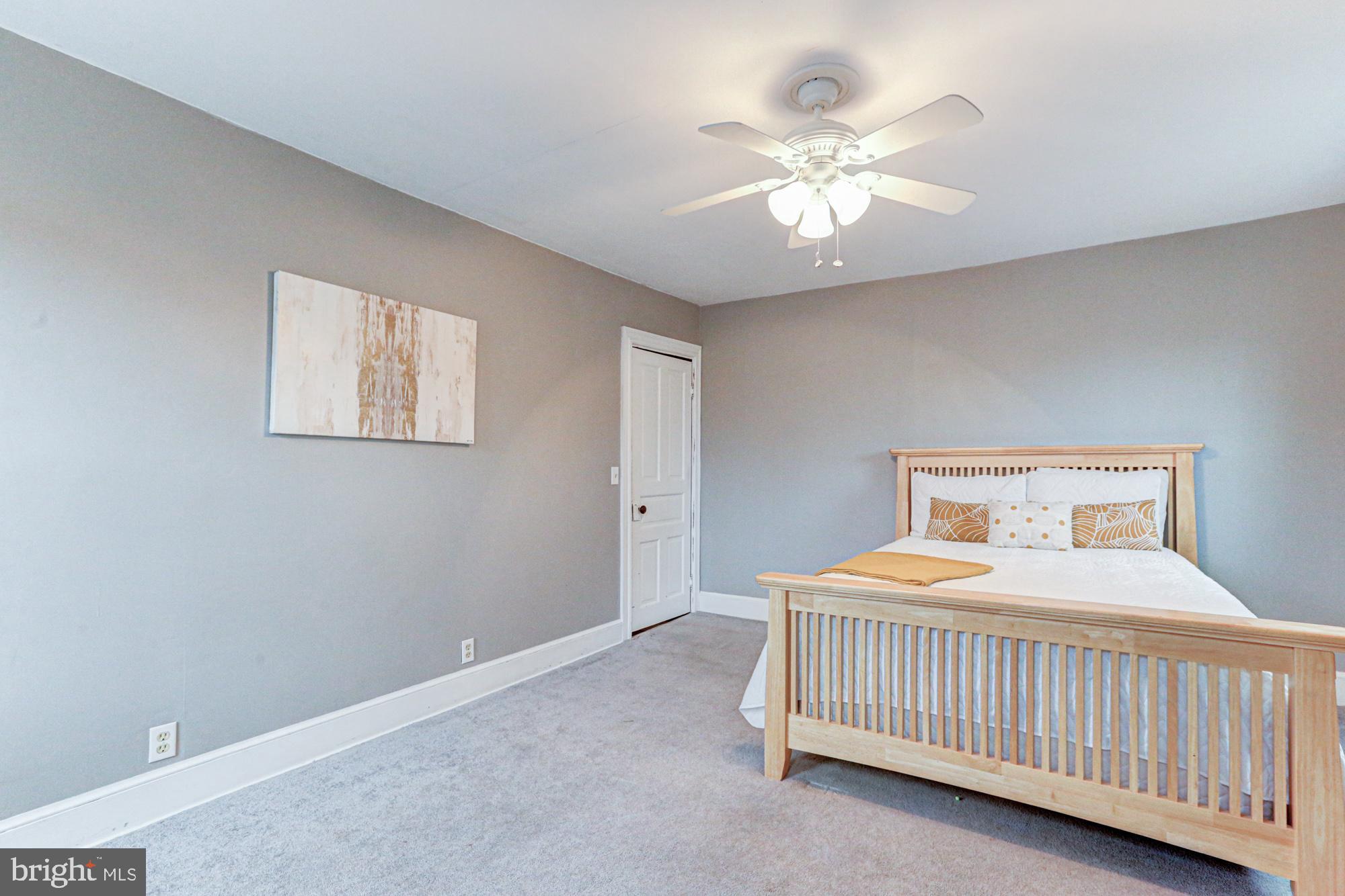 421 Main Street Clayton, DE 19938 - Photo 60 of 77 a bedroom with a bed and a chandelier
