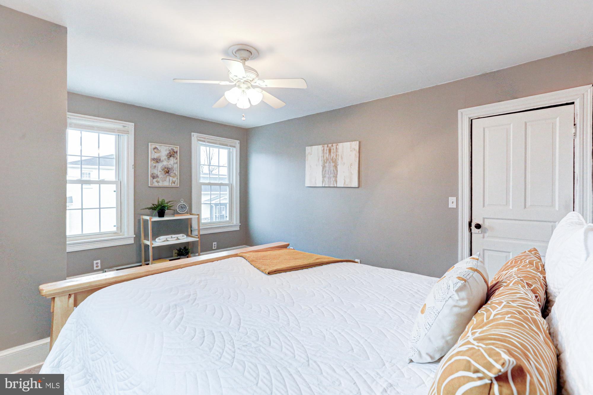 421 Main Street Clayton, DE 19938 - Photo 61 of 77 a bedroom with a large bed and a chandelier
