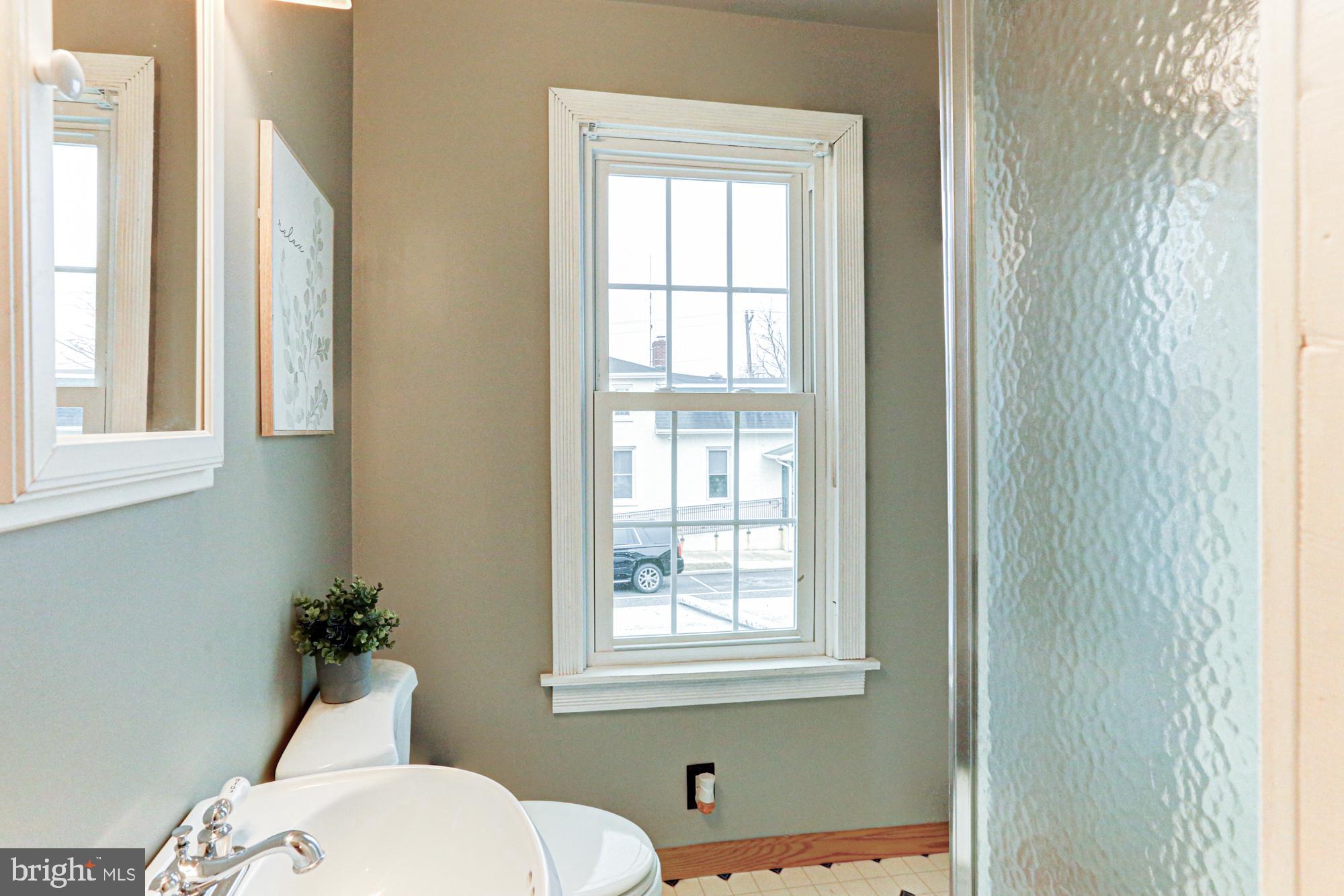 421 Main Street Clayton, DE 19938 - Photo 62 of 77 a bathroom with a sink toilet and window