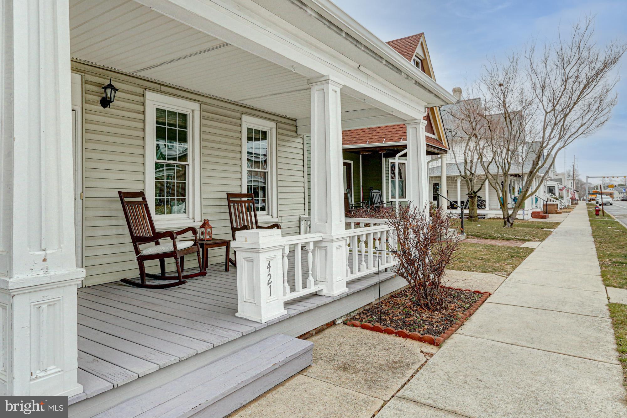 421 Main Street Clayton, DE 19938 - Photo 7 of 77 a view of a deck with table and chairs with wooden floor and fence