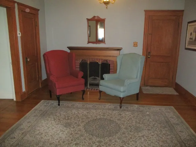 a bedroom with a bed lamp and wooden floor