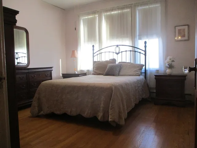a living room with hard wood floors and a window