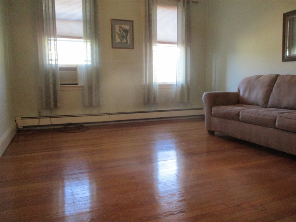 84 Tudor Street, Unit 4 Chelsea, MA 02150 - Photo 13 of 16 a living room with hard wood floors and a window