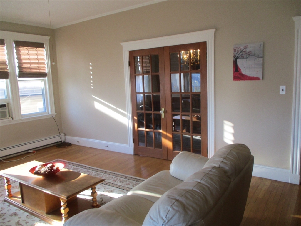 84 Tudor Street, Unit 4 Chelsea, MA 02150 - Photo 4 of 16 a living room with furniture and a window