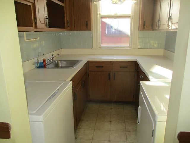 a kitchen with a sink and cabinets