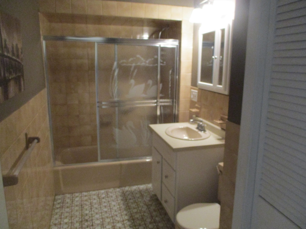 84 Tudor Street, Unit 4 Chelsea, MA 02150 - Photo 10 of 16 a bathroom with a sink toilet and shower