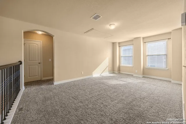 an empty room with windows and closet