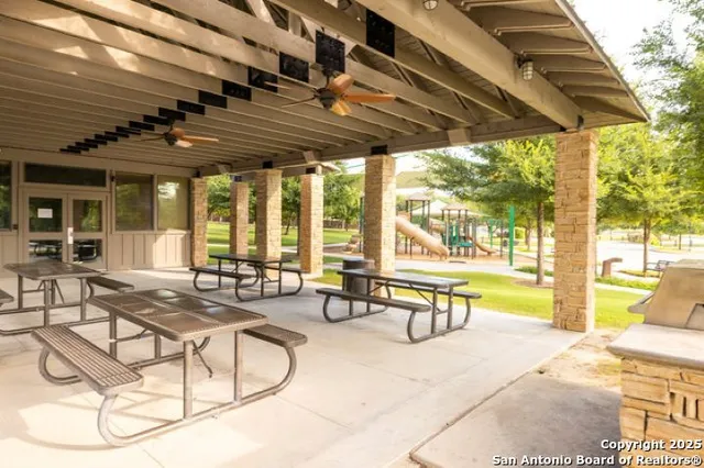 a building outdoor space with patio furniture and a potted plant