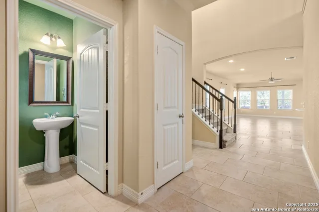 a view of a hallway with windows and stairs