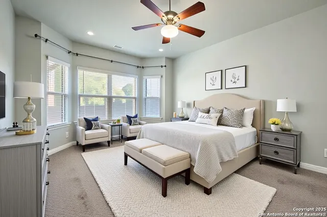 a bedroom with a bed couch and window