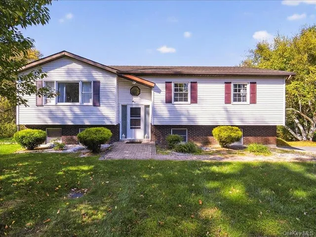 a front view of a house with a yard and porch