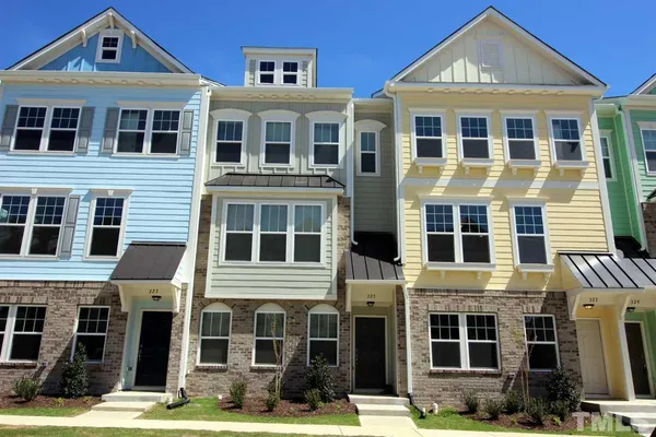 a front view of a residential apartment building with a yard