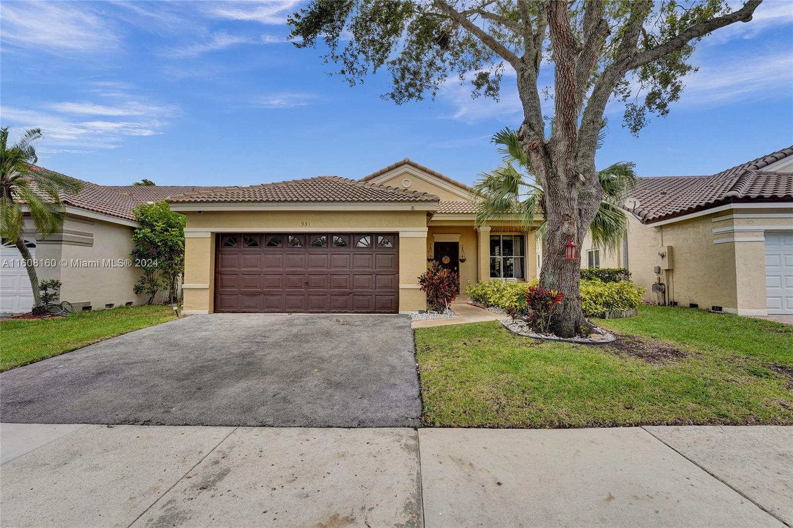 931 Falling Water Road Weston, FL 33326 - Photo 1 of 20 front view of a house with a yard