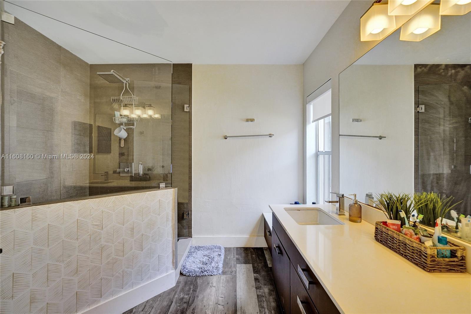 931 Falling Water Road Weston, FL 33326 - Photo 7 of 20 a bathroom with a tub sink and mirror