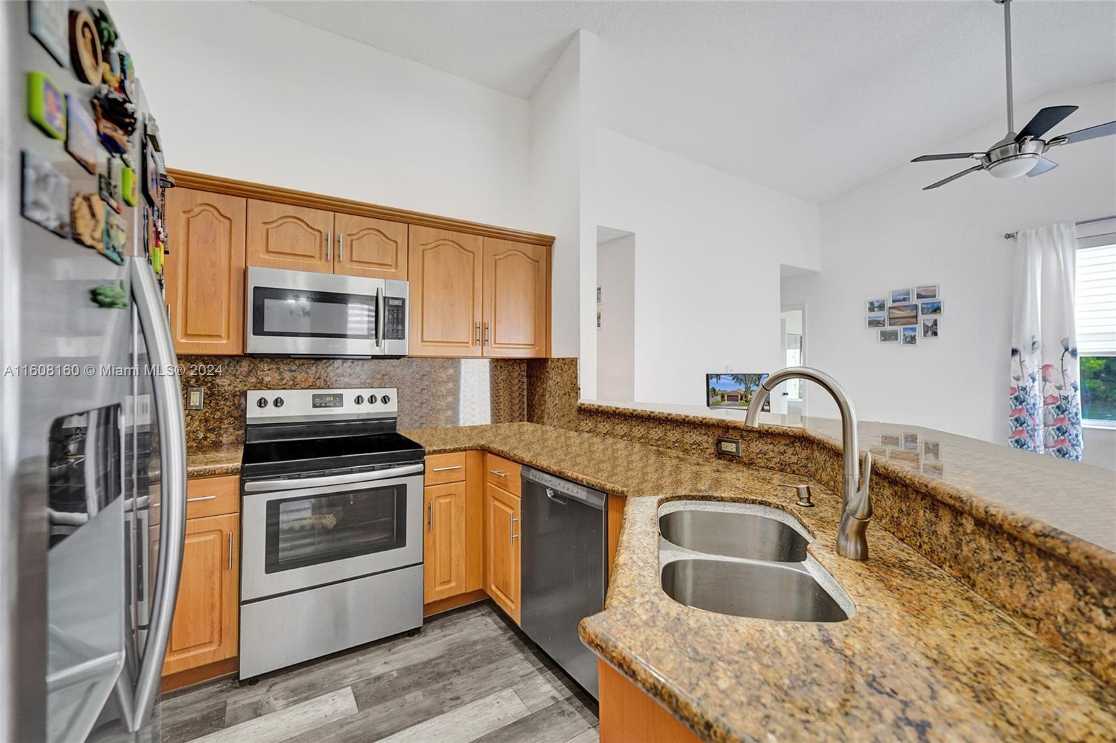 931 Falling Water Road Weston, FL 33326 - Photo 8 of 20 a kitchen with a stove sink and microwave