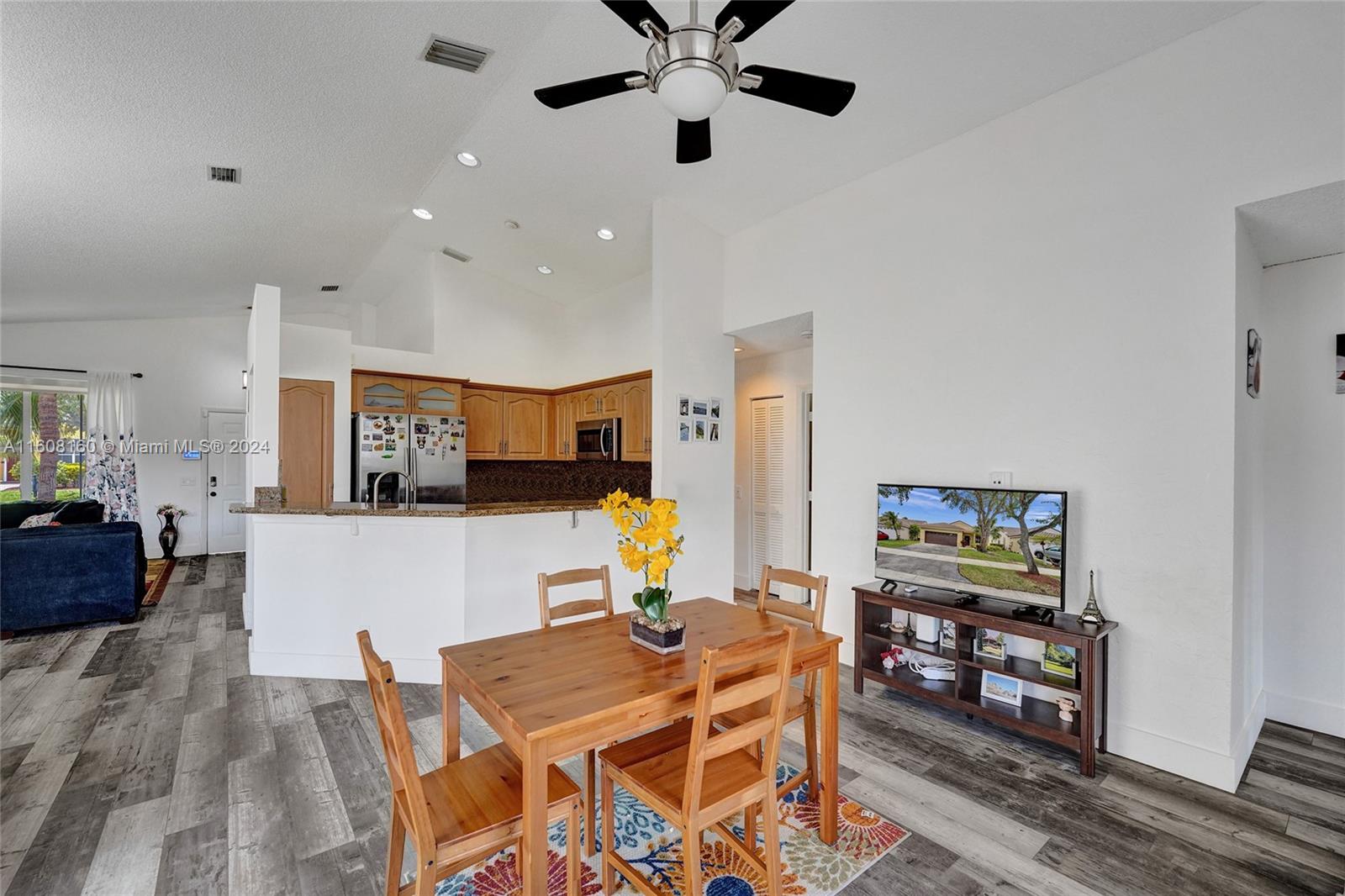 931 Falling Water Road Weston, FL 33326 - Photo 9 of 20 a living room with furniture and a flat screen tv