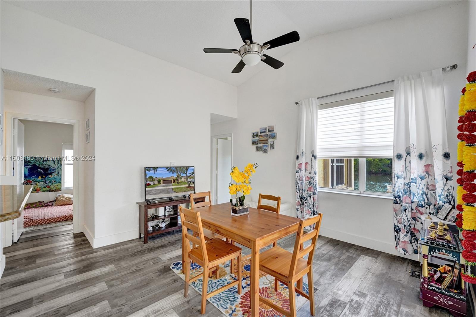 931 Falling Water Road Weston, FL 33326 - Photo 10 of 20 a view of a dining room with furniture window and wooden floor