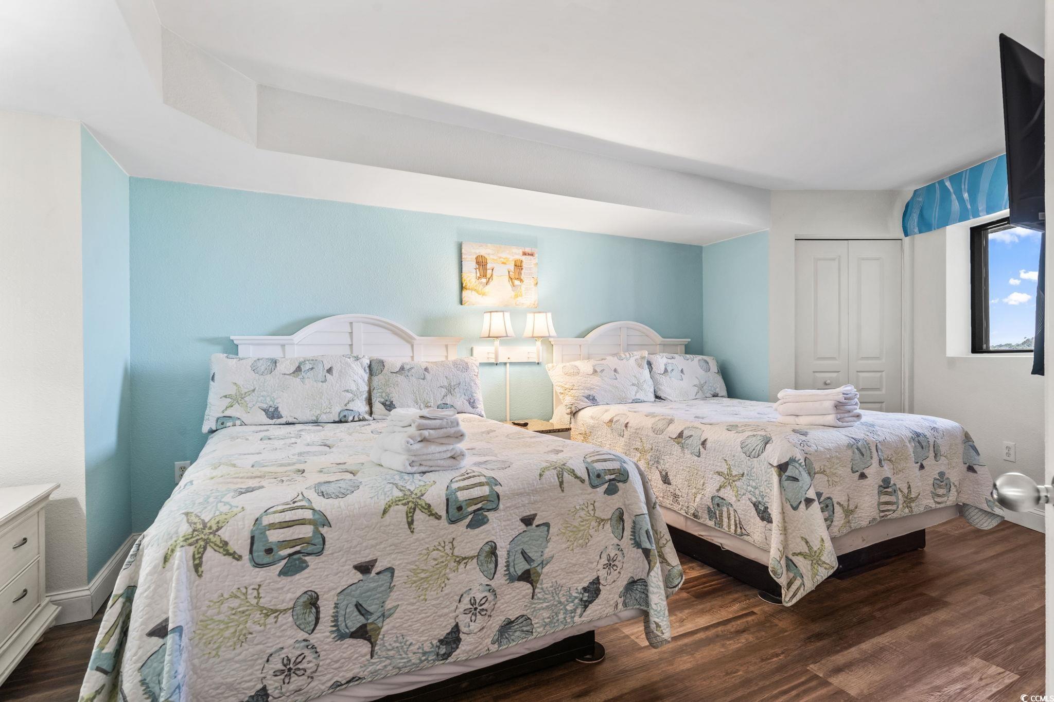 7100 North Ocean Boulevard, Unit 616 Myrtle Beach, SC 29572 - Photo 12 of 23 Bedroom with a closet and dark wood finished floors