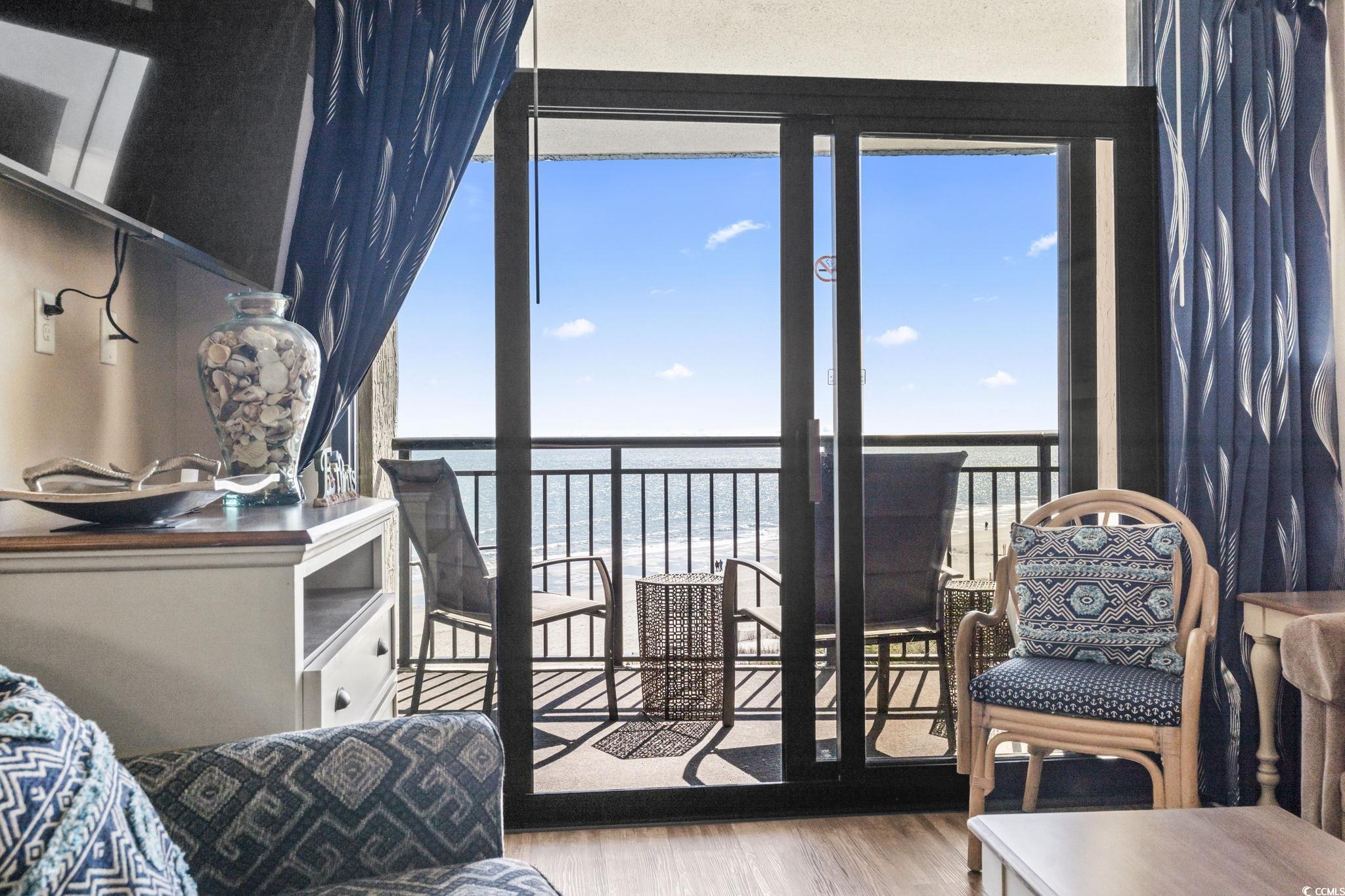 7100 North Ocean Boulevard, Unit 616 Myrtle Beach, SC 29572 - Photo 15 of 23 Bedroom with multiple windows, view of water and beach, and wood finished floors
