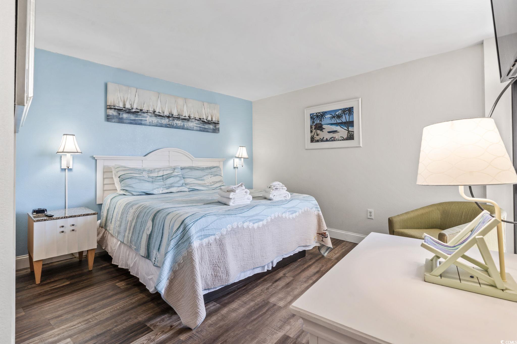 7100 North Ocean Boulevard, Unit 616 Myrtle Beach, SC 29572 - Photo 16 of 23 Bedroom with dark wood-style flooring and baseboards