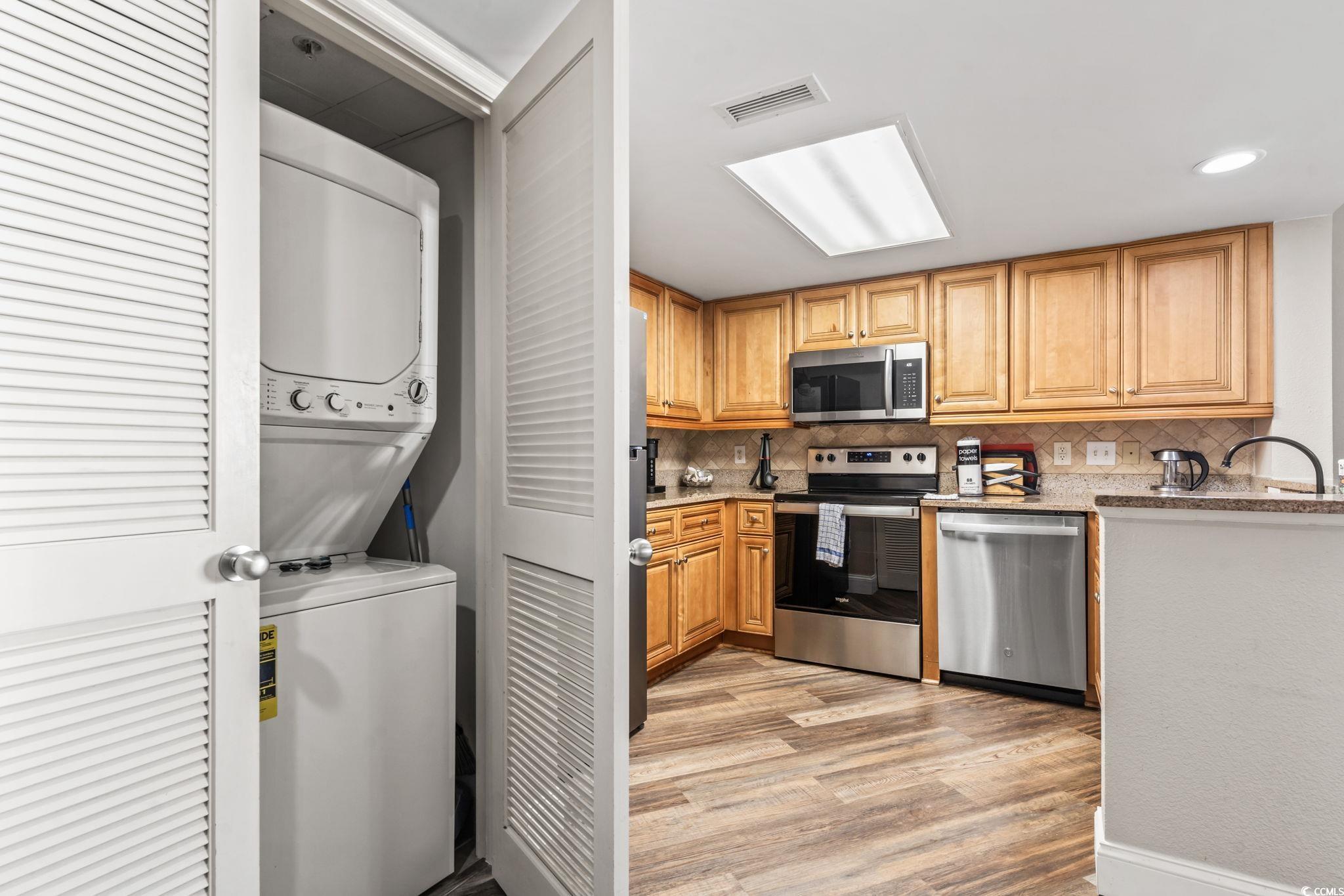 7100 North Ocean Boulevard, Unit 616 Myrtle Beach, SC 29572 - Photo 5 of 23 Kitchen featuring stainless steel appliances, tasteful backsplash, light wood-type flooring, light stone countertops, and recessed lighting