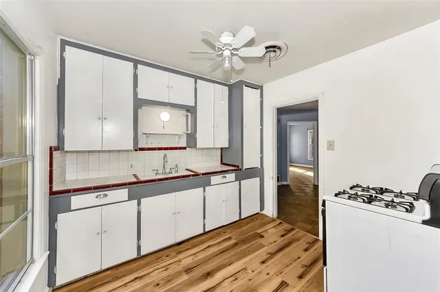 a kitchen with a sink appliances and cabinets