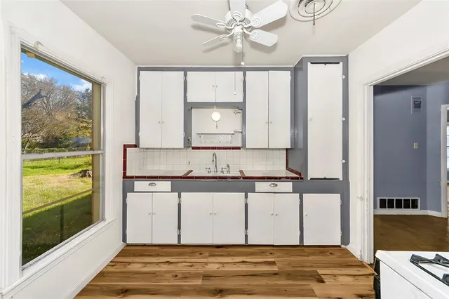 a view of a kitchen from a hallway