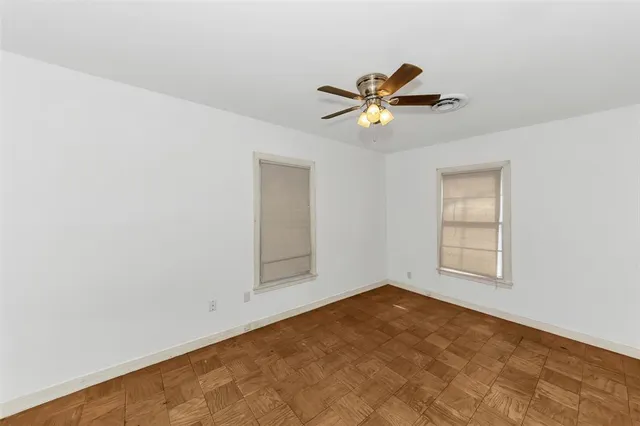 a view of room with a ceiling fan and window
