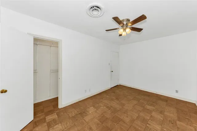 a view of a hallway with a ceiling fan