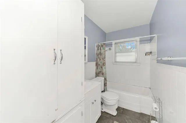 a bathroom with a shower a toilet and sink