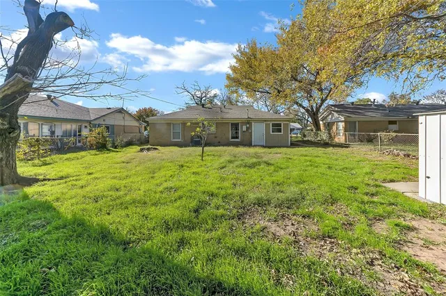 a front view of house with yard and trees