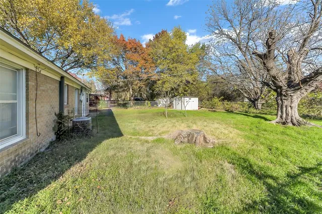 a view of a backyard with large trees