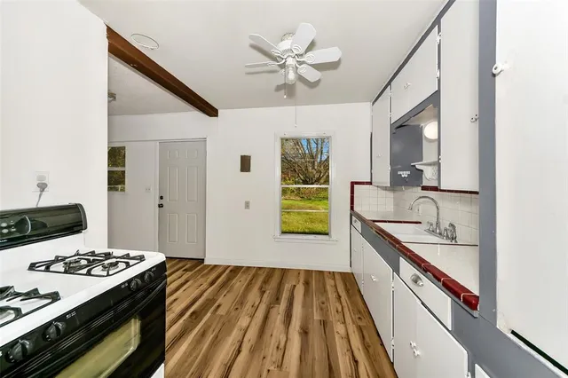 a kitchen with a stove and a sink