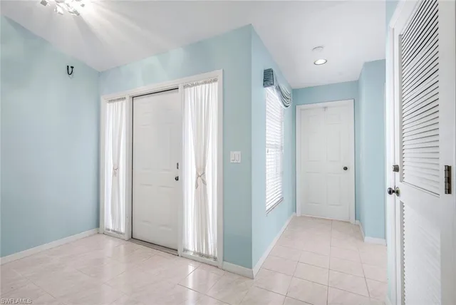a view of a hallway with closet and entryway