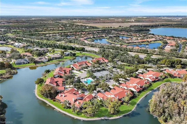 an aerial view of lake and residential houses with outdoor space