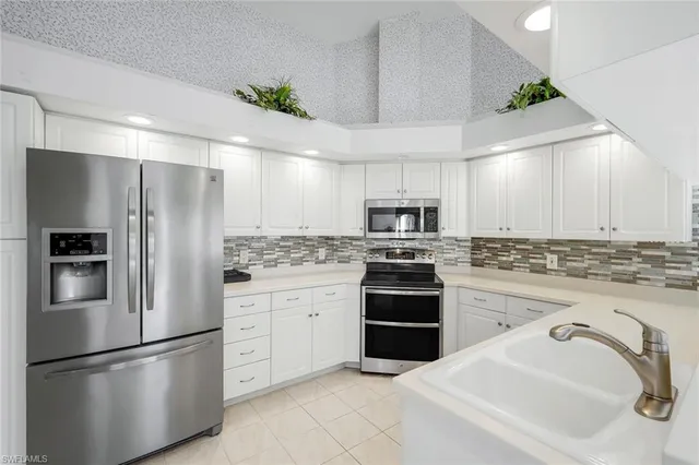 a kitchen with stainless steel appliances a refrigerator sink and stove