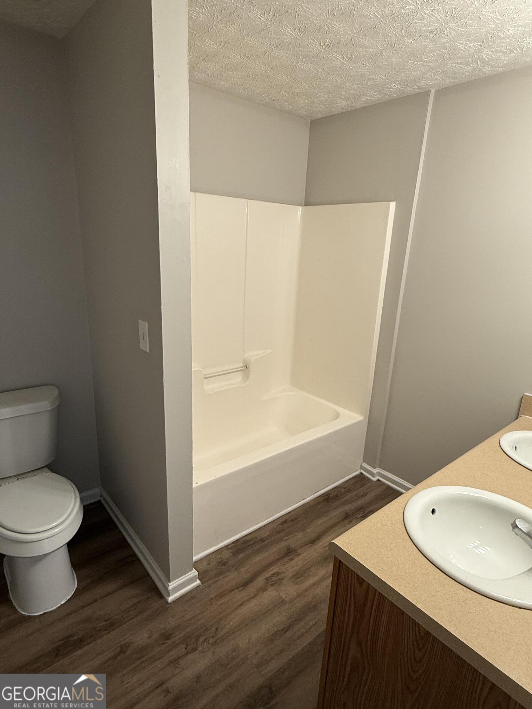 6132 Ruth Street Southwest Covington, GA 30014 - Photo 19 of 33 a bathroom with a sink toilet and shower