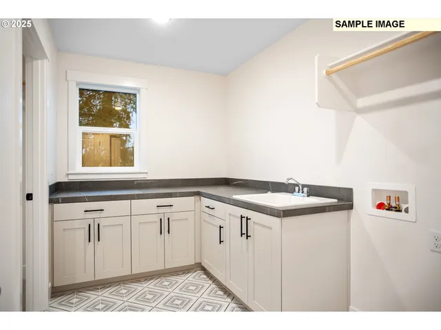 a kitchen with a sink cabinets and window